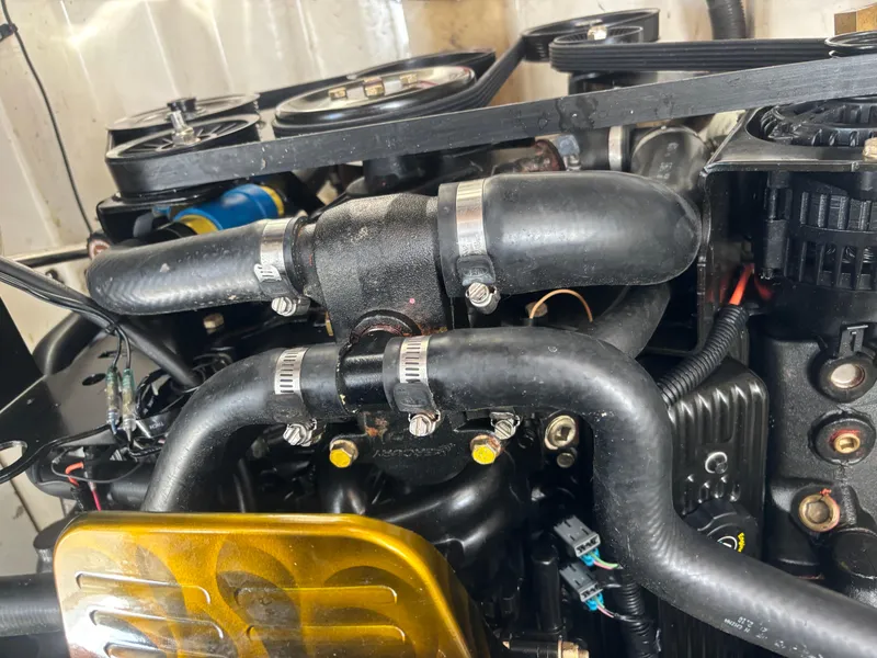 Slide: The Image of Engine components of a 2006 Sea Ray 260 Sundancer boat, featuring hoses and belts. - 31