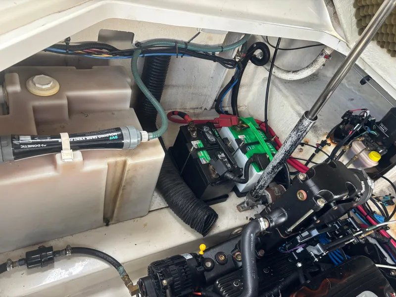 Slide: The Image of Engine compartment of a 2006 Sea Ray 260 Sundancer boat, showing battery and components. - 34