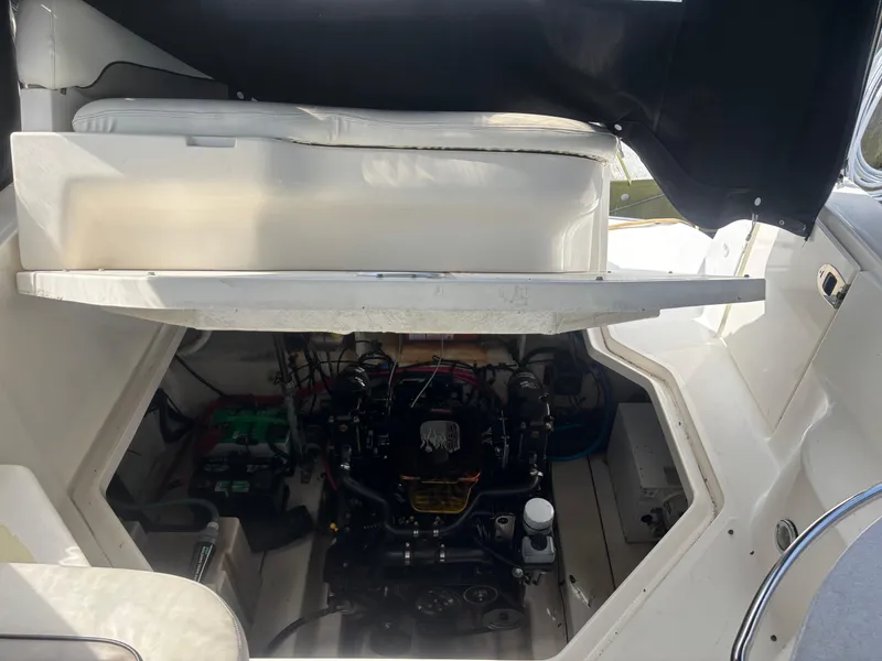 Slide: The Image of Engine compartment of a 2006 Sea Ray 260 Sundancer boat, showcasing mechanical components. - 35