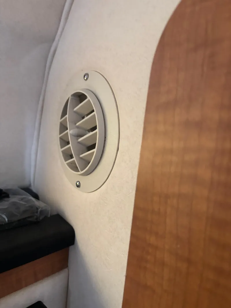Slide: The Image of Air vent inside 2006 Sea Ray 260 Sundancer boat cabin, featuring wood paneling. - 36
