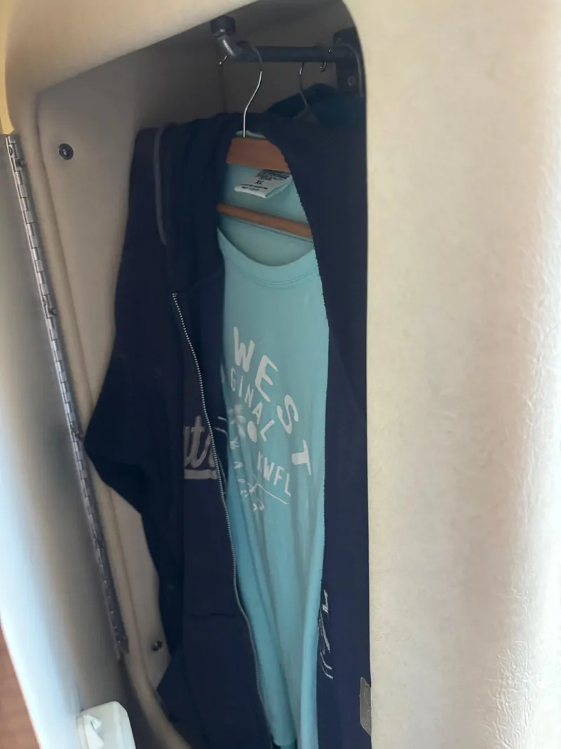 Slide: The Image of Clothes hanging in a closet on a 2006 Sea Ray 260 Sundancer boat. - 37
