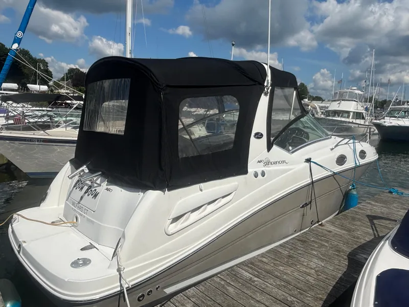 Slide: The Image of 2006 Sea Ray 260 Sundancer boat docked at marina under cloudy sky. - 7