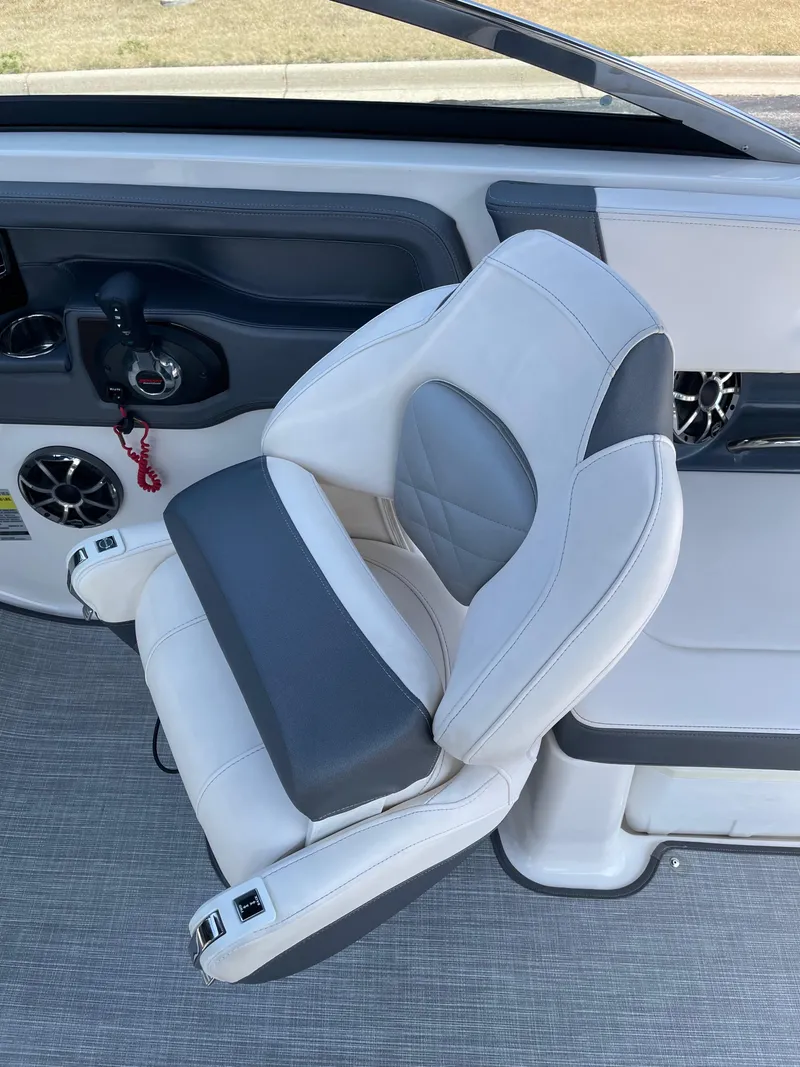 Slide: The Image of 2018 Chaparral 267 SSX boat interior with white and gray captain's chair. - 11
