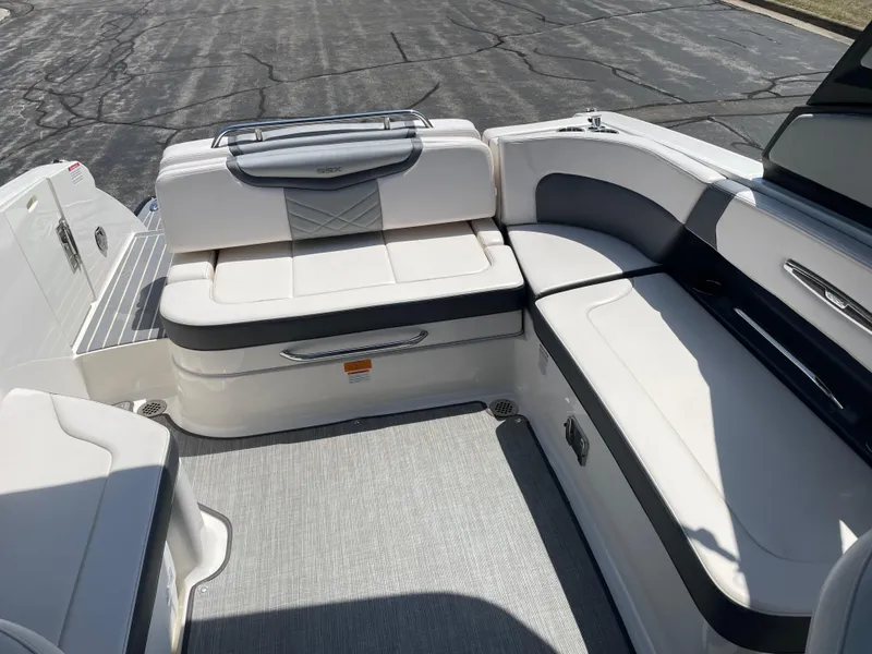 Slide: The Image of 2018 Chaparral 267 SSX boat interior with white seating and gray accents. - 13