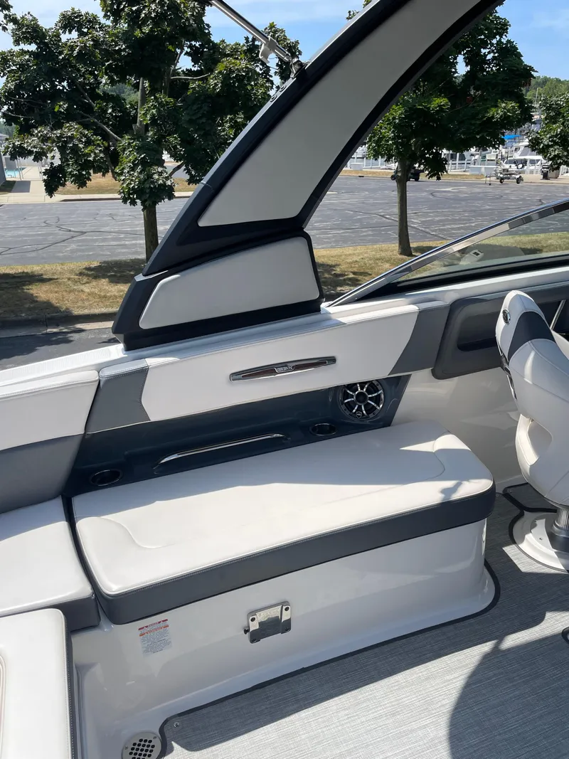 Slide: The Image of 2018 Chaparral 267 SSX boat interior with white seating and modern design elements. - 15