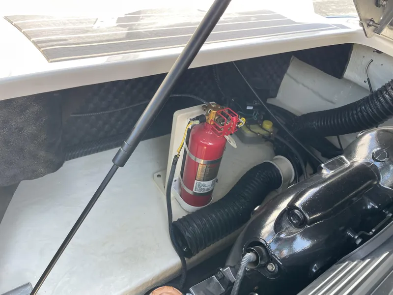Slide: The Image of Engine compartment of 2018 Chaparral 267 SSX with fire extinguisher and components. - 23