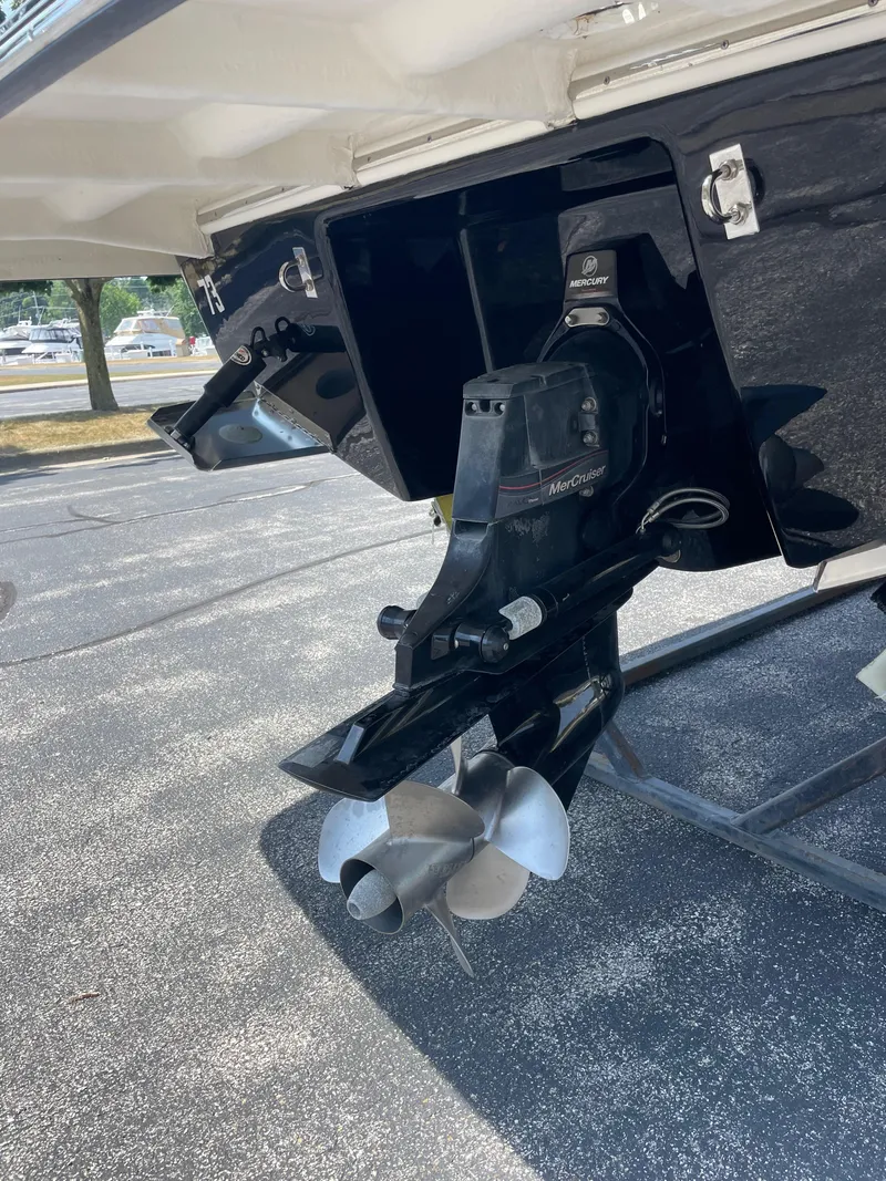 Slide: The Image of 2018 Chaparral 267 SSX boat with MerCruiser outdrive and propeller, parked on pavement. - 26