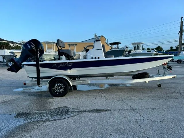 Slide: The Image of 2026 Avid 19 FSX boat on trailer, parked outdoors, side view. - 6