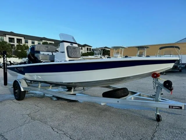 Slide: The Image of 2026 Avid 19 FSX boat on trailer in parking lot, clear sky background. - 7