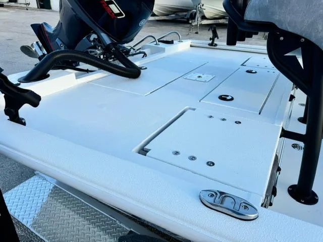 Slide: The Image of 2026 Avid 19 FSX boat deck with motor, featuring storage compartments and sleek design. - 9