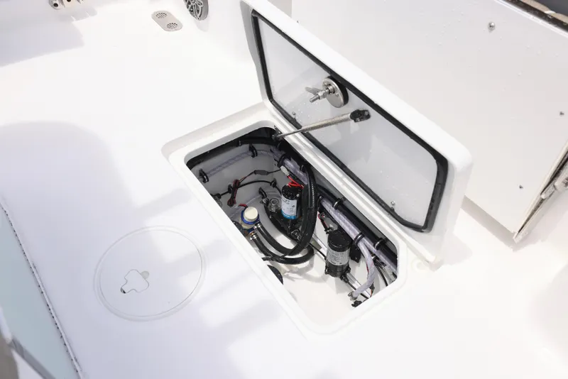 Slide: The Image of 2026 Sea Hunt Gamefish 27 Coffin Box open compartment with visible wiring and components. - 13