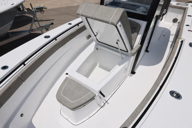 Slide: The Image of 2026 Sea Hunt Gamefish 27 Coffin Box with open storage compartment on deck. - 24