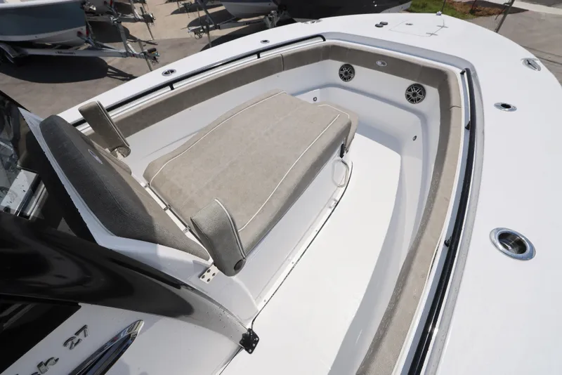 Slide: The Image of 2026 Sea Hunt Gamefish 27 Coffin Box boat interior with cushioned seating and speakers. - 28