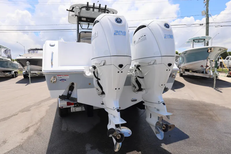 Slide: The Image of 2026 Sea Hunt Gamefish 27 Coffin Box with dual Yamaha 200 engines, parked outdoors. - 29