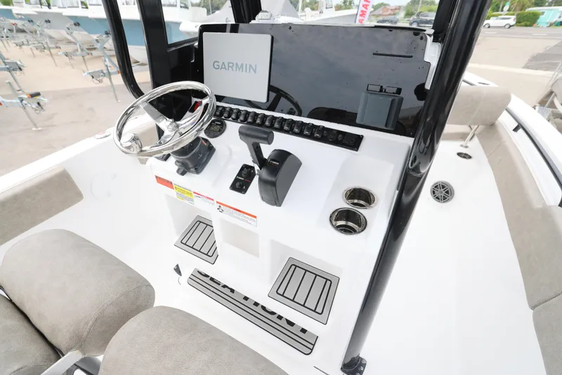 Slide: The Image of 2026 Sea Hunt Gamefish 27 Coffin Box helm with Garmin display and steering wheel. - 3