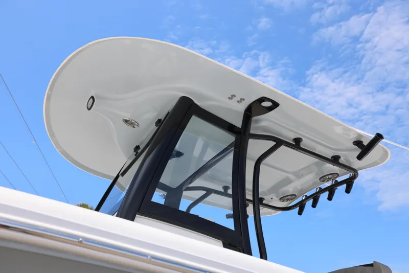 Slide: The Image of 2026 Sea Hunt Gamefish 27 Coffin Box boat with sleek T-top against blue sky. - 30