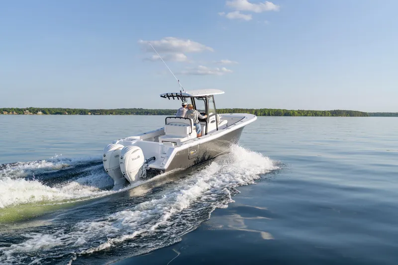 Slide: The Image of 2026 Sea Hunt Gamefish 27 Coffin Box cruising on calm water under clear skies. - 40