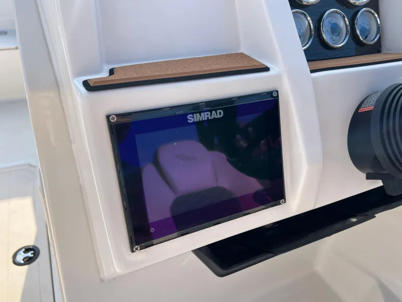 Slide: The Image of Simrad display on 2025 Starcraft SVX 231 IO boat dashboard with gauges. - 10
