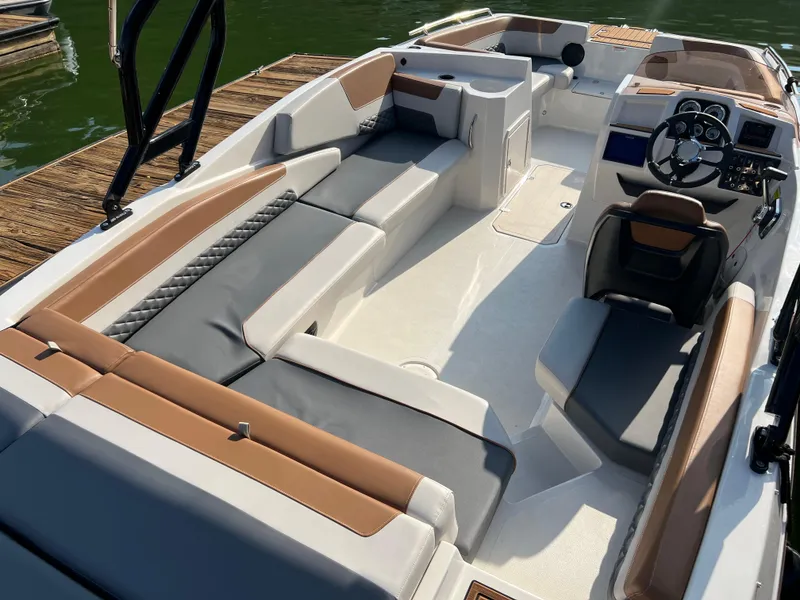 Slide: The Image of 2025 Starcraft SVX 231 IO boat interior with modern seating and steering console. - 12