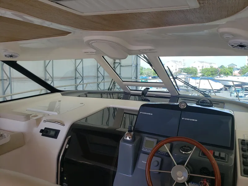 Slide: The Image of 2007 Tiara Yachts 4300 Sovran helm with Furuno navigation systems and wooden steering wheel. - 10