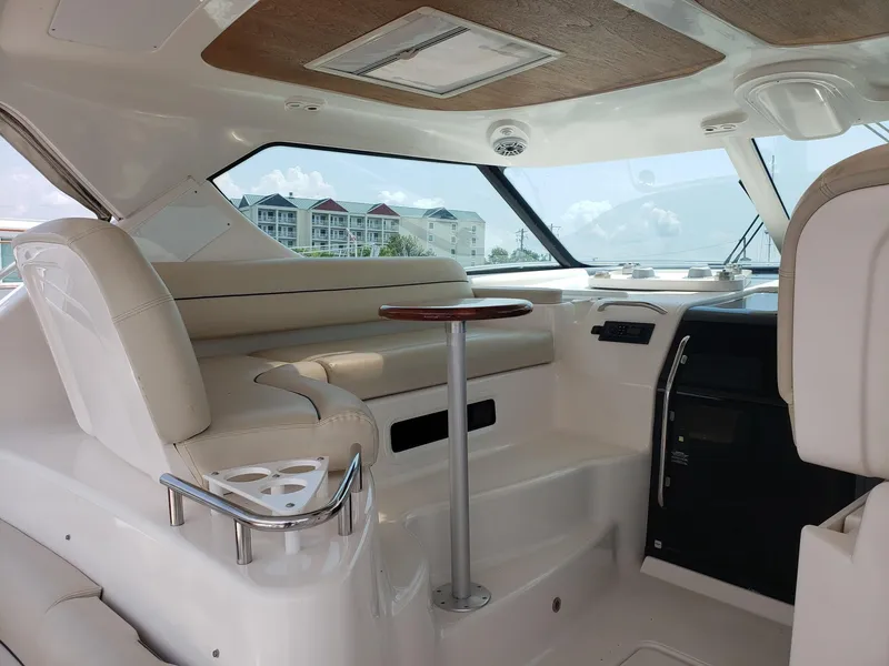 Slide: The Image of 2007 Tiara Yachts 4300 Sovran interior with beige seating and wooden accents. - 13