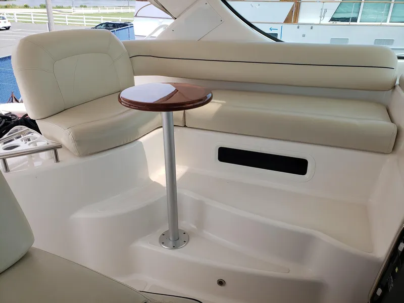 Slide: The Image of 2007 Tiara Yachts 4300 Sovran interior with cream seating and a small wooden table. - 14
