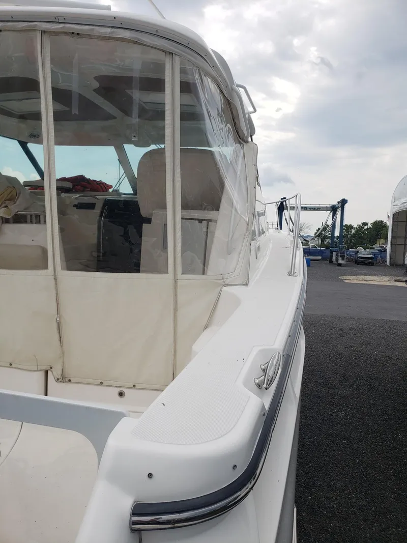 Slide: The Image of 2007 Tiara Yachts 4300 Sovran docked, featuring a sleek white exterior and covered cockpit. - 17