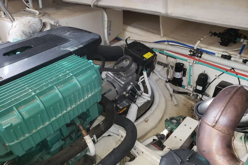 Slide: The Image of Engine room of a 2007 Tiara Yachts 4300 Sovran, showcasing mechanical components and wiring. - 30