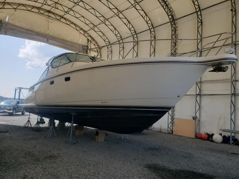 Slide: The Image of 2007 Tiara Yachts 4300 Sovran in storage, elevated on stands inside a covered facility. - 4