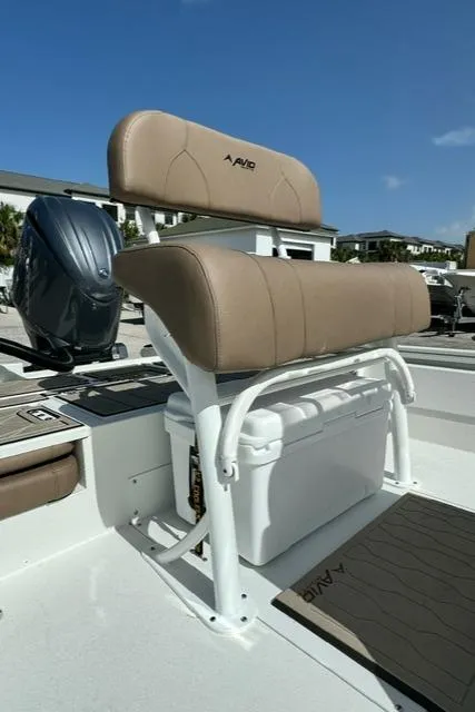Slide: The Image of Avid 21 Fusion 2026 boat seat with storage, featuring tan upholstery and white frame. - 12