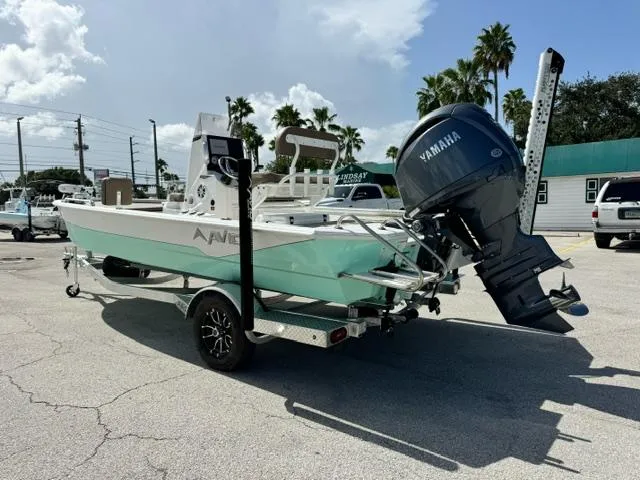 Slide: The Image of Avid 21 Fusion 2026 boat with Yamaha engine on trailer, parked outdoors. - 3