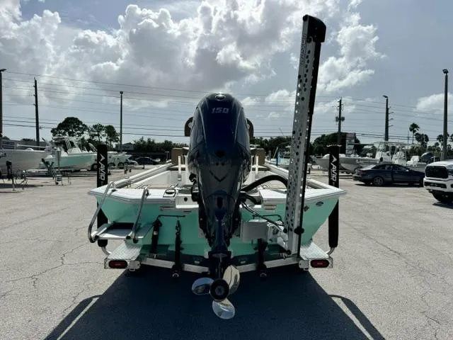 Slide: The Image of Avid 21 Fusion 2026 boat with outboard motor in a parking lot. - 4