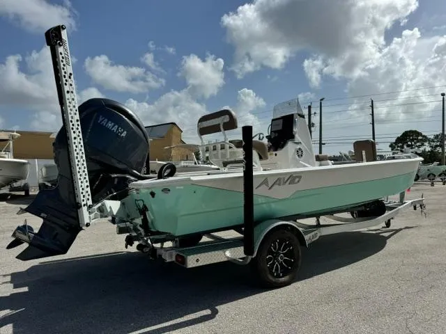 Slide: The Image of Avid 21 Fusion 2026 boat with Yamaha engine on trailer under cloudy sky. - 5