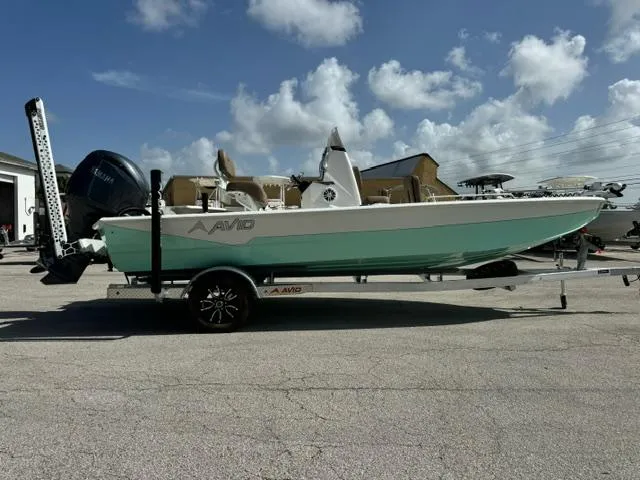Slide: The Image of Avid 21 Fusion 2026 boat on trailer under blue sky. - 6