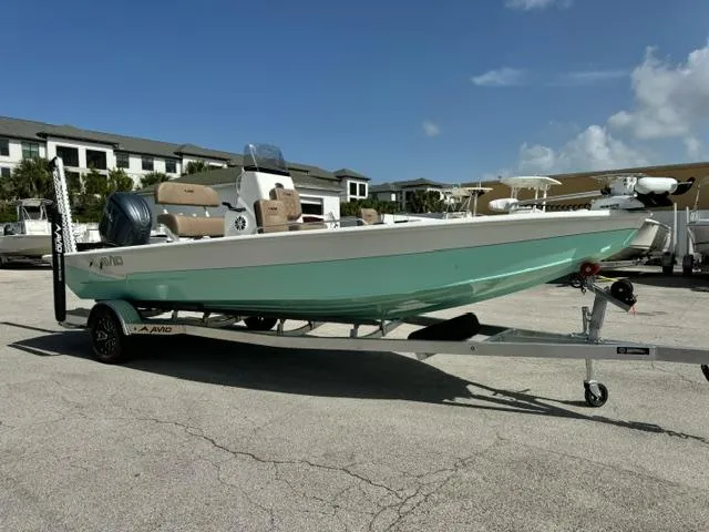 Slide: The Image of 2026 Avid 21 Fusion boat on trailer, parked outdoors under clear sky. - 7