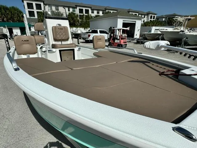 Slide: The Image of Avid 21 Fusion 2026 boat with brown seating, docked in a marina. - 8