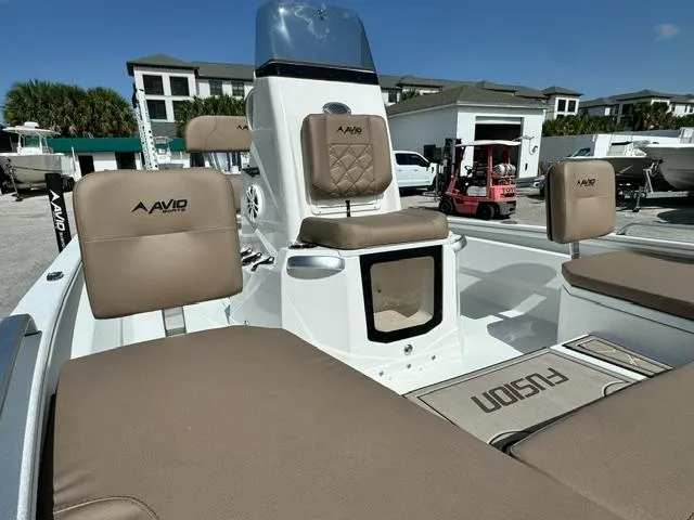 Slide: The Image of 2026 Avid 21 Fusion boat interior with tan seating and modern design. - 9