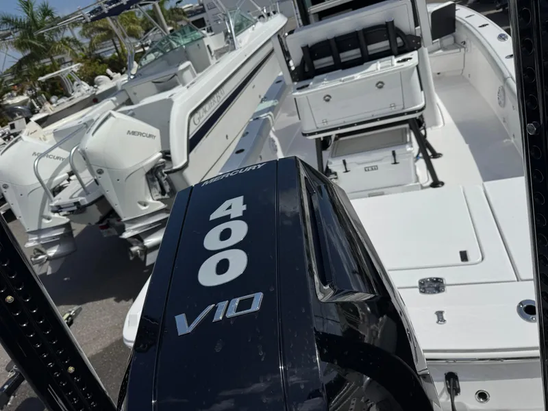 Slide: The Image of 2026 Blackfin 262 HB boat with Mercury 400 V10 engine, docked alongside similar vessels. - 12