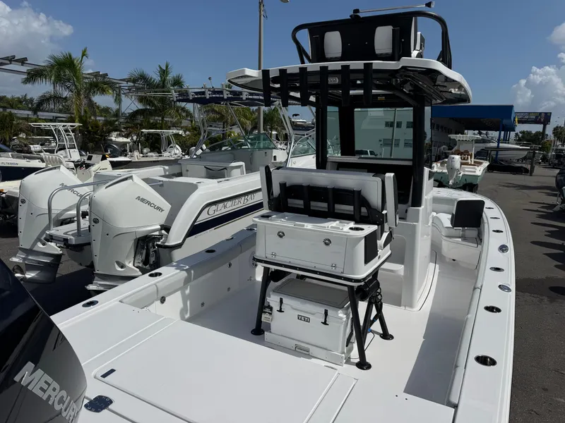 Slide: The Image of 2026 Blackfin 262 HB boat with dual Mercury engines, docked under a clear blue sky. - 13