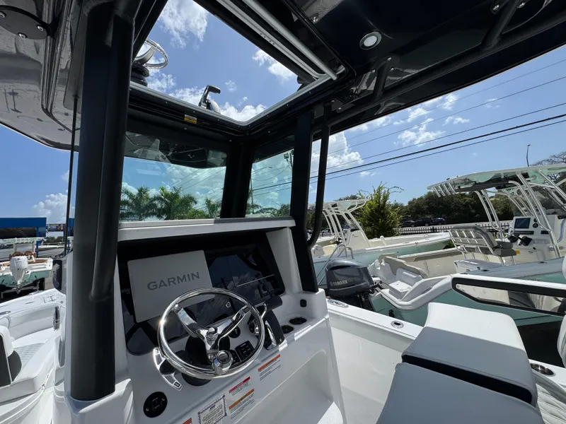 Slide: The Image of 2026 Blackfin 262 HB boat interior with Garmin navigation system, under clear blue sky. - 21