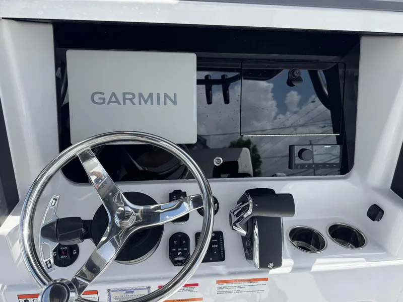 Slide: The Image of 2026 Blackfin 262 HB boat dashboard with Garmin navigation system and steering wheel. - 23