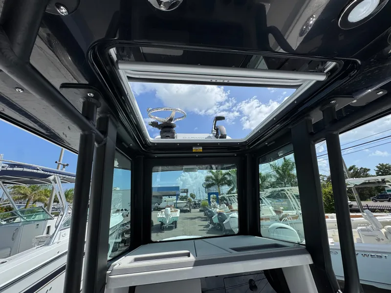 Slide: The Image of Interior view of 2026 Blackfin 262 HB boat with open sunroof and clear sky. - 25