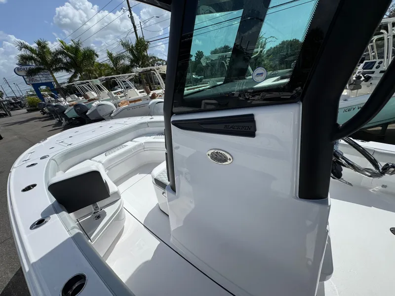 Slide: The Image of 2026 Blackfin 262 HB boat with sleek design, docked under sunny skies. - 26