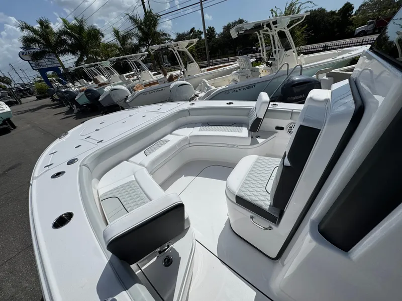 Slide: The Image of 2026 Blackfin 262 HB boat interior with seating, parked among other boats. - 27