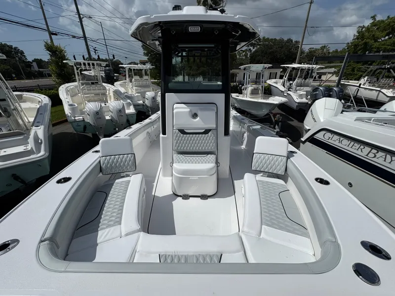 Slide: The Image of 2026 Blackfin 262 HB boat with spacious seating and modern design in a marina setting. - 30