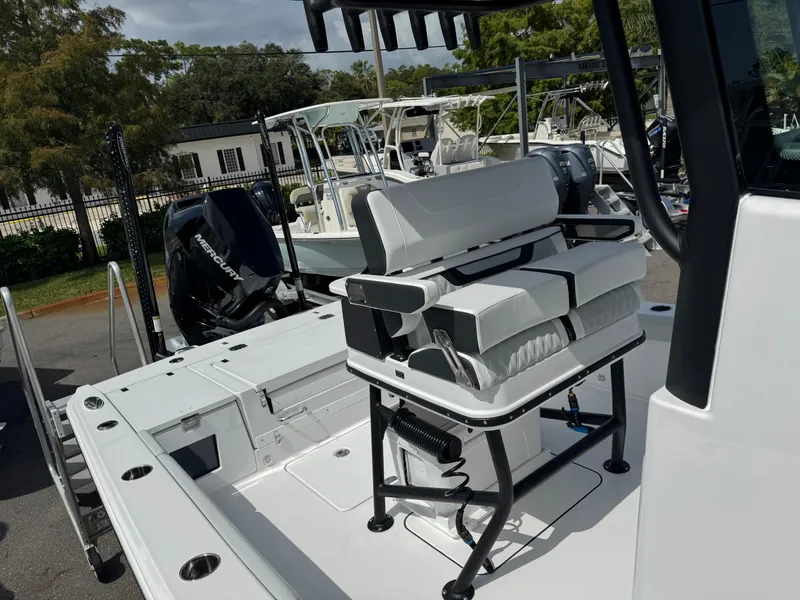 Slide: The Image of 2026 Blackfin 262 HB boat with seating and Mercury outboard engine in a marina setting. - 35