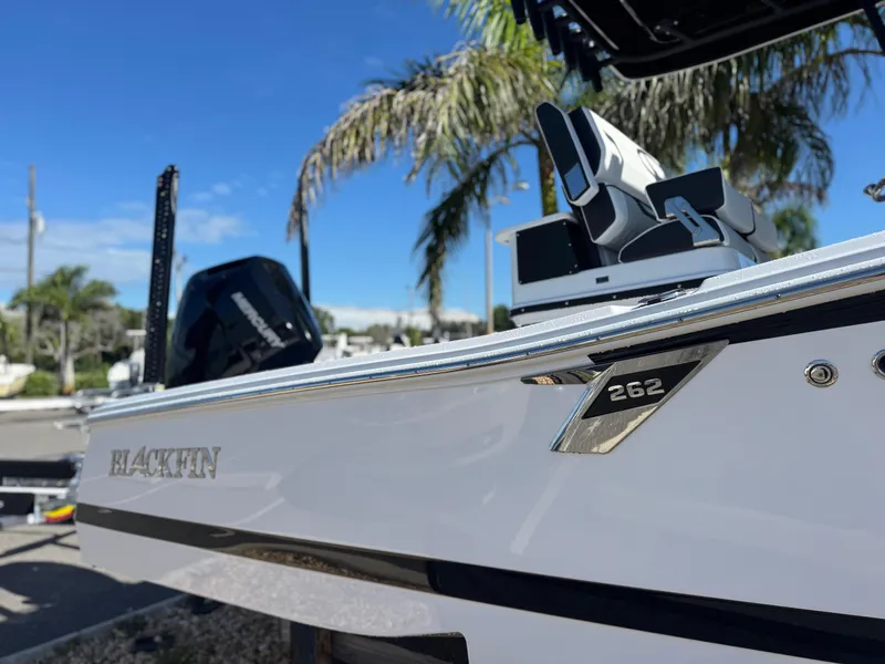 Slide: The Image of 2026 Blackfin 262 HB boat, sleek design, parked outdoors with palm trees in the background. - 4