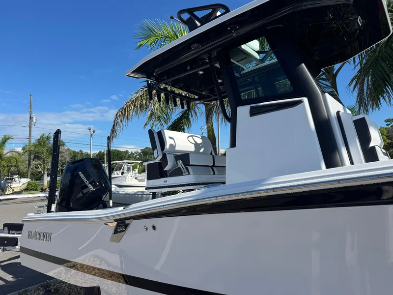 Slide: The Image of 2026 Blackfin 262 HB boat with sleek design, parked outdoors under clear blue sky. - 5