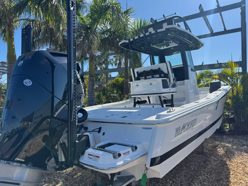 Slide: The Image of 2026 Blackfin 262 HB boat with powerful outboard motor, surrounded by tropical palm trees. - 7