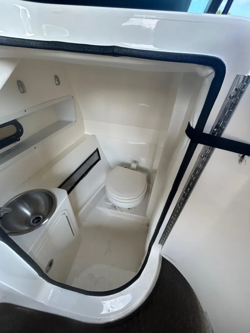 Slide: The Image of 2015 Sea Ray 270 Sundeck Outboard boat bathroom with sink and toilet. - 11